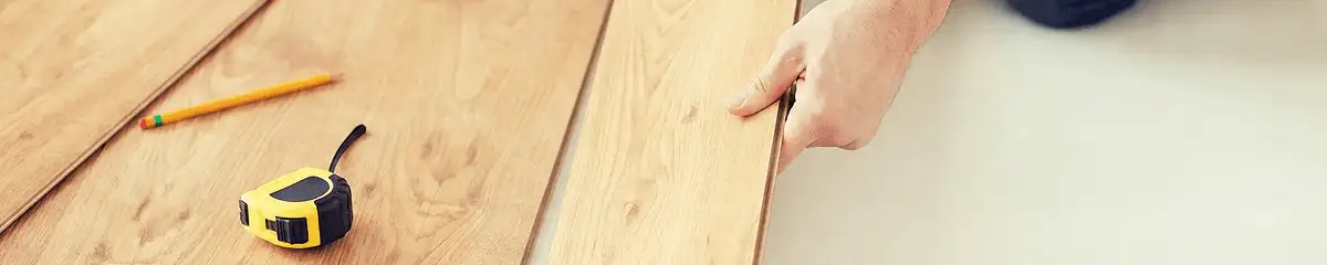 A professional installing wood flooring in Jersey City, NJ