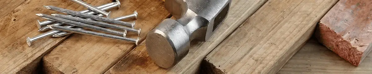 Hammer and nails on hardwood flooring boards in Jersey City, NJ