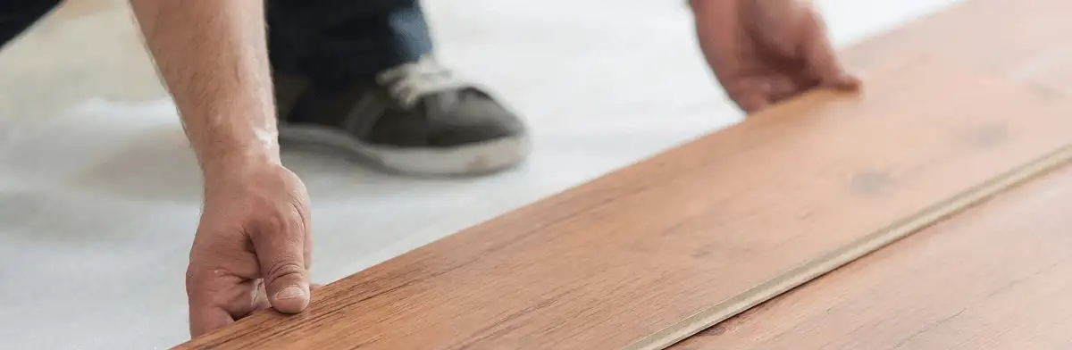 A professional installing laminate flooring in Jersey City, NJ